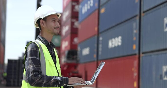 Asian male supervisor inspects the containers before sending them out.
