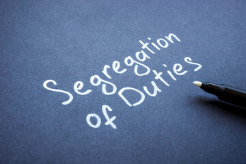 Handwritten words Segregation of duties on the dark paper. - obrazy, fototapety, plakaty