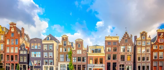 Foto op Aluminium Amsterdam  Panoramic view of famous Amsterdam houses - background isolated on white. Various traditional houses in the historic center of Amsterdam. Amsterdam, Holland, Netherlands © Taiga