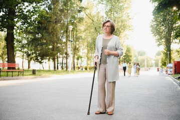 Woman with her walking stick in the park.