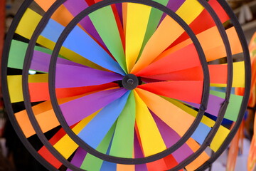 circular windmill painted colorfully like a rainbow. LGBTI+ diversity of colours.