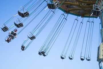 Teenage girl on chain swing carousel