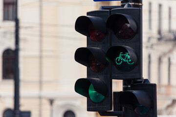 Bicycle next to a traffic semaphore both turned green at crossroads