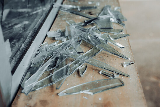 Close up to glass shards of a window after smashing during a burglary action