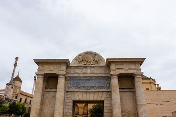 Fototapeta premium Córdoba, Spain, September 13, 2021: The Puerta del Puente (Gate of the Bridge) is a Renaissance gate in Andalusia. Built-in the 16th century to commemorate a visit to the city by King Philip II.