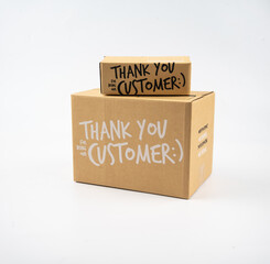 Two closed cardboard boxes taped up, and there is a Thank you for being our customer beside the parcel box for delivery and shopping online concept design isolated on white background.