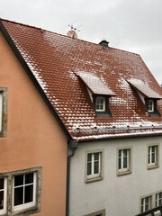 Fairytale snowfall over the roofs in Rothenburg, Germany. Snow falls against the roof of German houses.