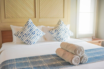 Light grey towel on bed decoration in tropical bedroom interior