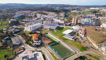 Obraz premium Santo Tirso, Portugal - January 1, 2022: DRONE AERIAL VIEW - The Pavilhão Desportivo Municipal (Municipal Sports Pavilion) and The Piscina Municipal (Swimming Pool). Municipal Sports Complex.