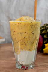 colorful healthy fresh fruit smoothy with assorted ingredients serve in glass.