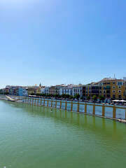 Obraz premium Seville, Spain, September 12, 2021: Situated on the left banks of the Guadalquivir River, Triana is one of the most essential, charismatic, and colorful neighborhoods of the Andalusian city.