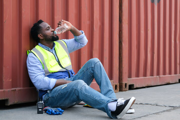 African american worker drinking water to quench their thirst after hard work.