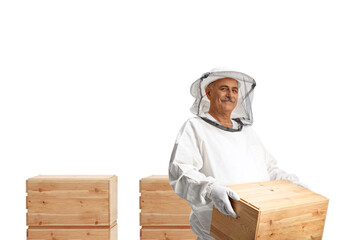 Mature bee keeper holding a wooden box and smiling