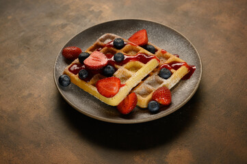 beautiful waffles on a dark background in a plate