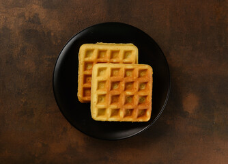 beautiful waffles on a dark background in a plate