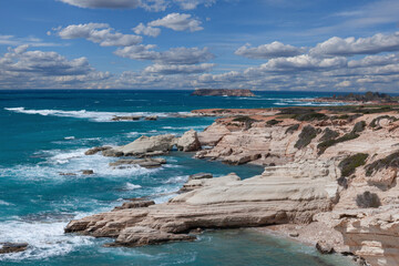 Fototapeta na wymiar Big waves break on the rocky shore on the mediterranean sea.Cyprus
