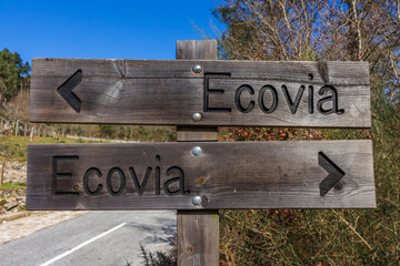 Eco-way direction sign at hiking trail Ecovia do Vez near Arcos de Valdevez, Portugal. Ecovia do Vez wooden pathways along the riverside.