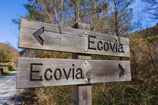 Eco-way direction sign at hiking trail Ecovia do Vez near Arcos de Valdevez, Portugal. Ecovia do Vez wooden pathways along the riverside.