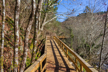 The river hiking trail Ecovia do Vez near Arcos de Valdevez, Portugal. Ecovia do Vez wooden pathways along the riverside.