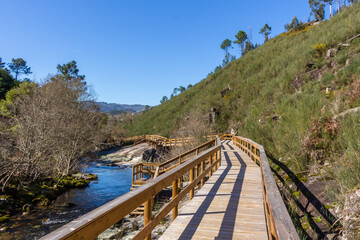The river hiking trail Ecovia do Vez near Arcos de Valdevez, Portugal. Ecovia do Vez wooden pathways along the riverside.