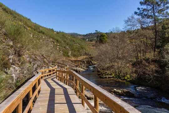 The river hiking trail Ecovia do Vez near Arcos de Valdevez, Portugal. Ecovia do Vez wooden pathways along the riverside.