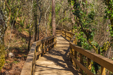 The river hiking trail Ecovia do Vez near Arcos de Valdevez, Portugal. Ecovia do Vez wooden pathways along the riverside.