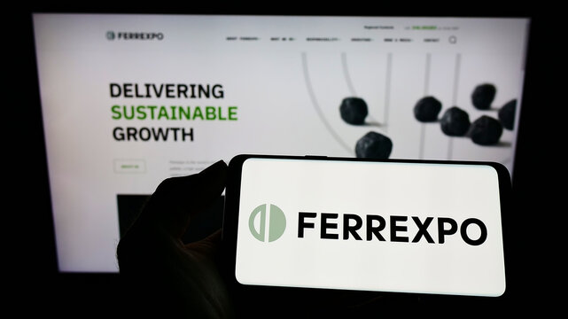 Stuttgart, Germany - 01-29-2022: Person holding smartphone with logo of Swiss commodity trading company Ferrexpo plc on screen in front of website. Focus on phone display.