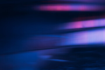 Blur light flare. Bokeh neon glow. Futuristic radiance. Defocused ultraviolet navy blue pink purple color flecks glare on dark modern abstract background.