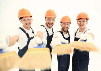 smiling group of builders with a paint brush