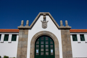 Fototapeta na wymiar Santo Tirso, Portugal, April 3, 2022: The Santo Tirso Municipal Market façade. The Coat of Arms of the city at the entrance.