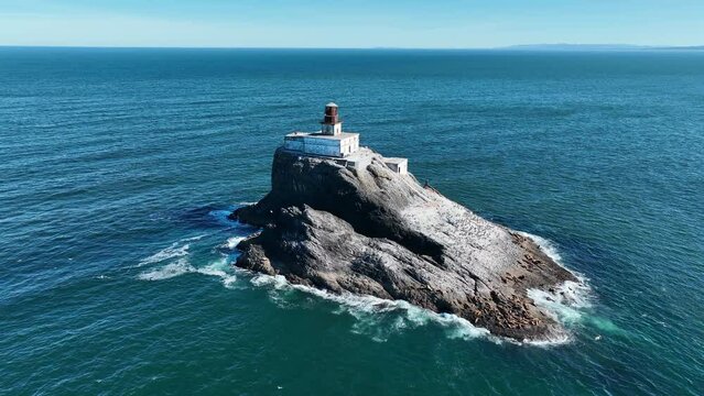 The Pacific Ocean surrounds the deactivated Tillamook Rock Lighthouse off the scenic Oregon coast. The isolated, historic lighthouse was originally built in 1880.