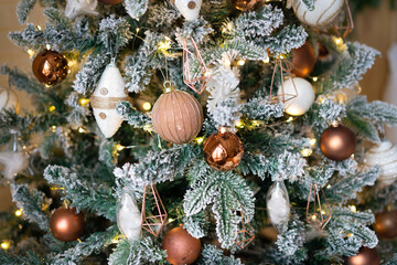 Close-up of decorations on the Christmas tree from garlands, lanterns and balls.