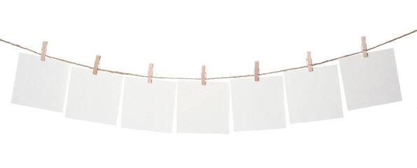 Clothespins with empty notepapers on string against white background. Space for text © New Africa