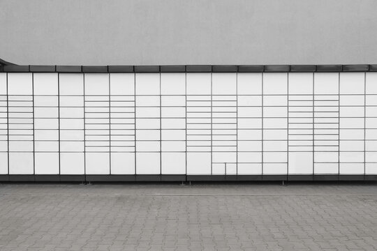 Modern parcel locker with many postal boxes outdoors