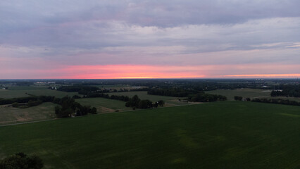 Fototapeta na wymiar Sunset shot from drone overlooking fields and farming area of Indiana