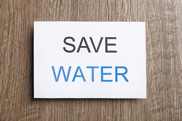 Card with words Save Water on wooden table, top view