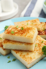 Delicious turnip cake with parsley on plate, closeup
