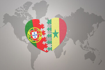 puzzle heart with the national flag of portugal and senegal on a world map background.Concept.