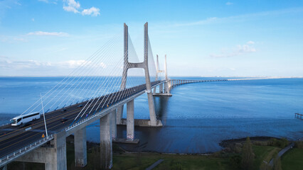 Obraz premium Aerial view of the Vasco da Gama Bridge is a cable-stayed bridge located in the city of Lisbon in Portugal and crosses the Tagus River. It is the second-longest bridge in Europe.