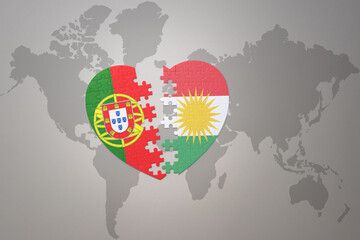 puzzle heart with the national flag of portugal and kurdistan on a world map background.Concept.