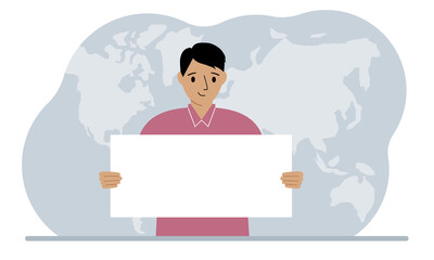 The concept of world attention. A man holds a white poster in his hands against the background of a world map.