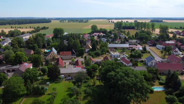 Flight to church in the middle of the village Great aerial view panorama overview drone footage at Countryside Hainichen in Europe Saxony Anhalt, summer 4k Cinematic view from above by Philipp Marnitz