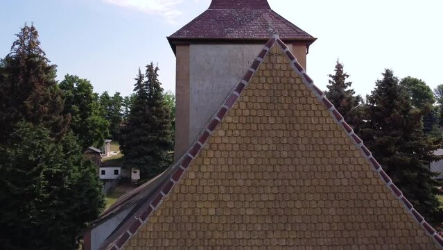 Over a rural church spire 
Daring aerial view flight lift off aerial drone footage
at Countryside village Hainichen in Europe Saxony Anhalt, summer 2022 4k Cinematic view from above by Philipp Marnitz