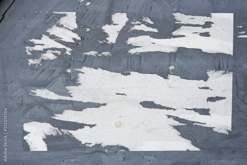 Poster abstract torn paper poster on the wall for background texture. the rough pattern of the street mater