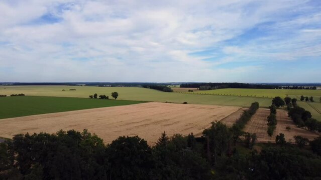Nature painted as if by artist
Beautiful aerial view flight fly backwards drone footage of wheat field Cornfield in Europe Saxony Anhalt at summer 2022. 4k Cinematic view from above by Philipp Marnitz