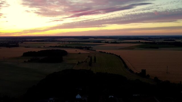 After sunset in the twilight
Daring aerial view flight sinking down drone footage
at Countryside village Hainichen in Europe Saxony Anhalt, summer 2022. 4k Cinematic view from above by Philipp Marnitz