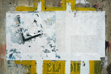 abstract torn paper poster on the wall for background texture. the rough pattern of the street...