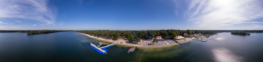 Fototapeta na wymiar Aerial of IJzeren Man lake with recreational outdoor activity sports and leisure park at the beach shore. Holidays and leisure in The Netherlands.
