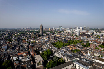 Fototapeta na wymiar Aerial view medieval Dutch city centre of Utrecht with cathedral towering over the city lit up by early morning sunlight. Cityscape urban area in The Netherlands
