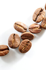 Roasted coffee beans isolated close up on white background, clipping path